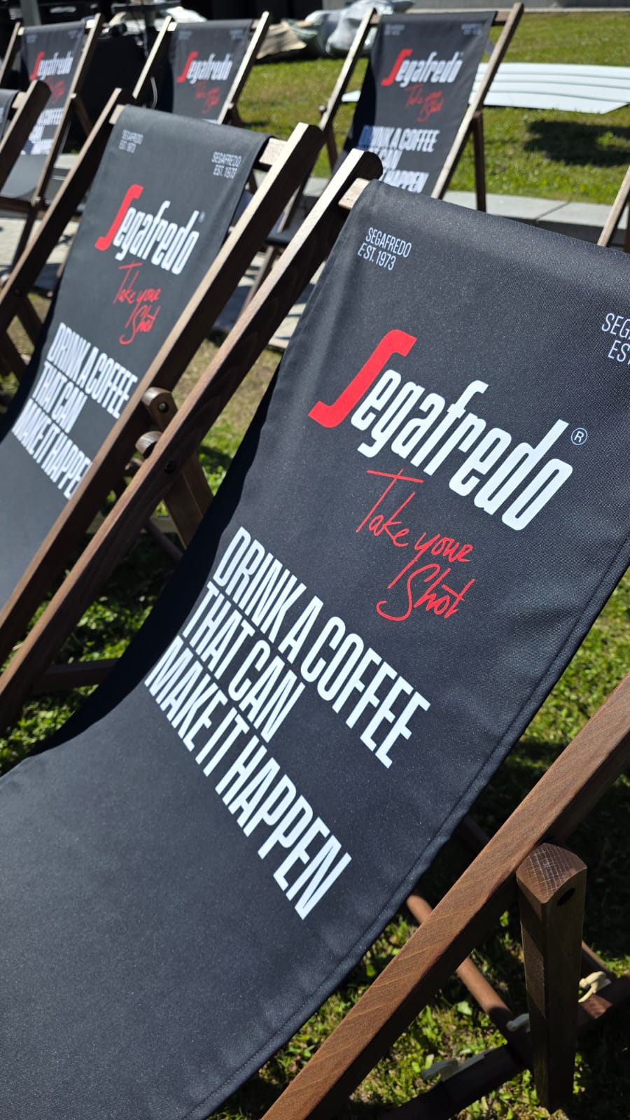 Segafredo 'Drink a coffee that can make it happen' branded deck chairs at the Fanzone