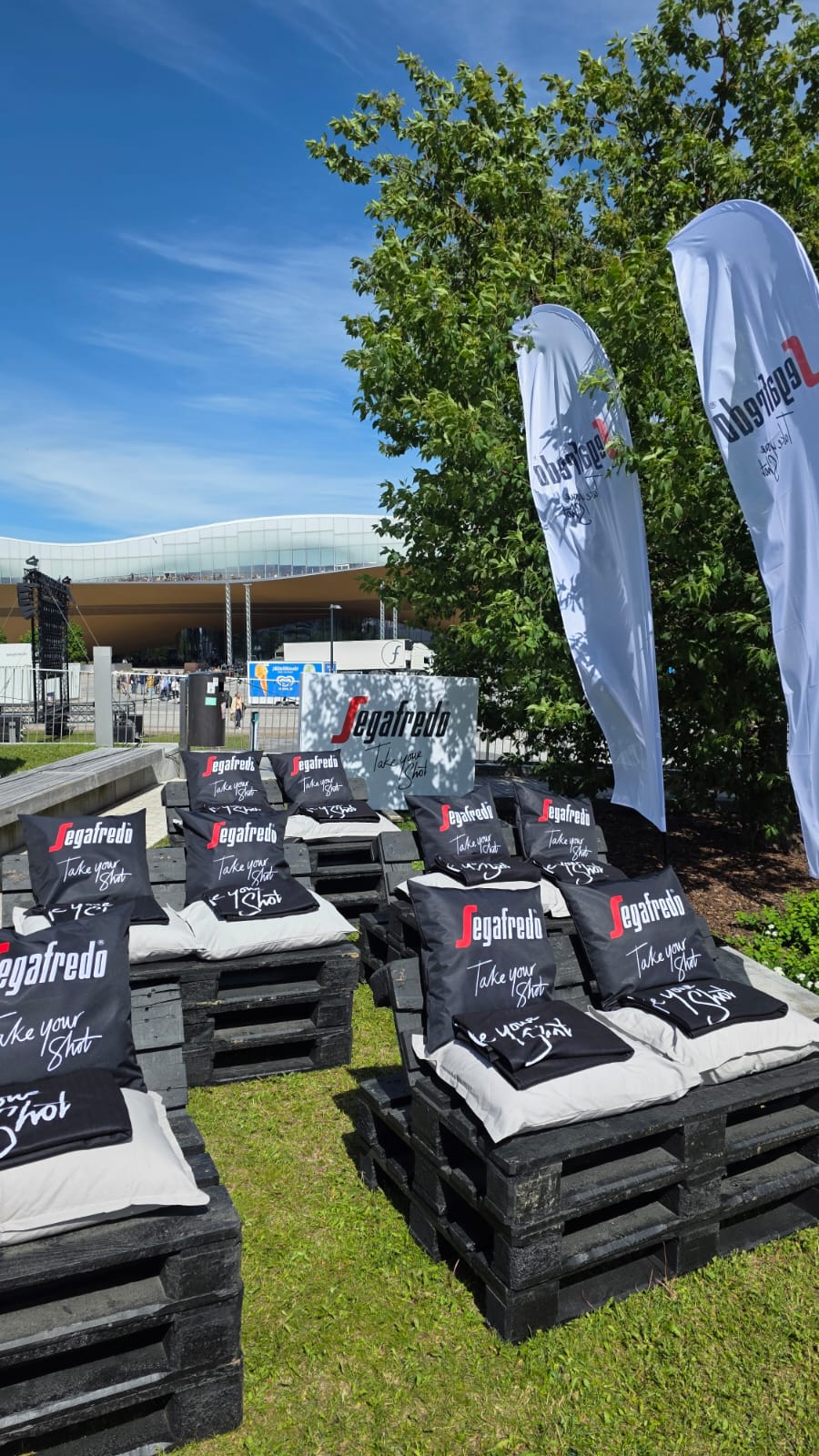 Segafredo lounge with beach flags and Musiikkitalo in the background at the FIFA World Cup Fanzone