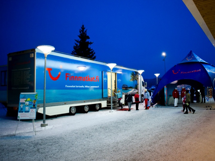 Finnmatkat roadshow truck and tent in evening lighting